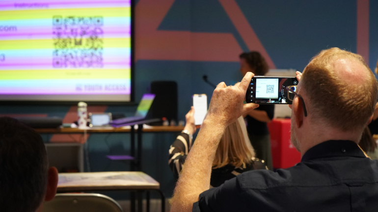 member taking photo at member meet 2025