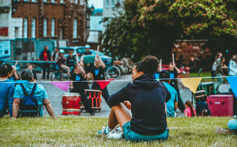 young person sat outside in park