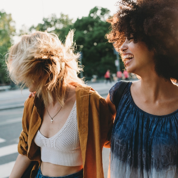 women walk on sidewalk